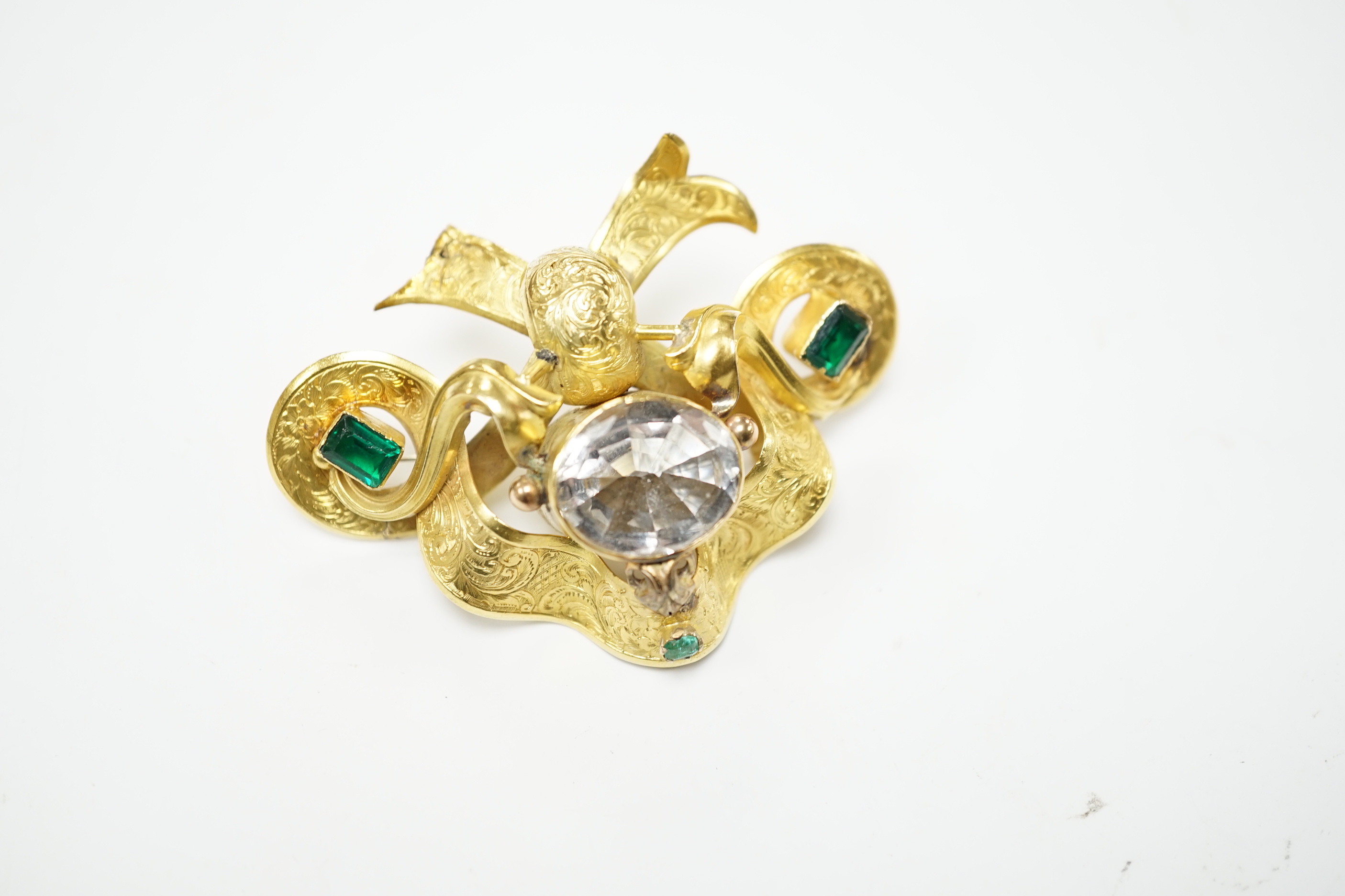 A Victorian engraved yellow metal and foil backed rock crystal and green stone set brooch, width 67mm, gross weight 16.8 grams (a.f.)